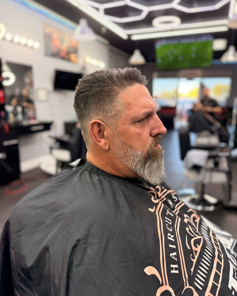 Taper fade with a trimmed gray beard