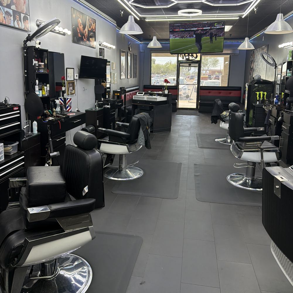 Inside the shop: two rows of barber chairs under the honeycomb ceiling lights